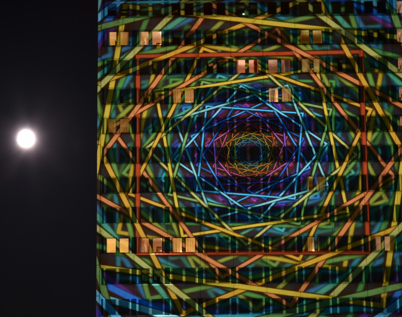 Foto: ein abstraktes Bild wurde per Lasershow auf ein hohes Gebäude projeziert