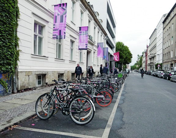 Foto: Anwohnerstraße mit PKW-Parkplätzen und Fahrradabstellanlagen