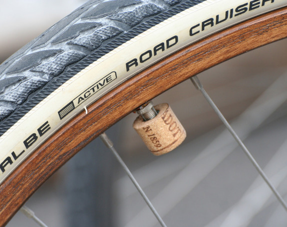 Foto: Detail des Rades eines Fahrrads, das Rad hat eine Holzfelde und einen Korken als Ventilkappe.